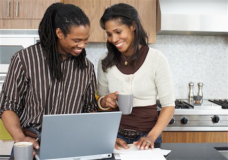 dreadlocks couples - Couple with Bills and Laptop Computer Stock Photo - Premium Royalty-Free, Code: 600-01276353