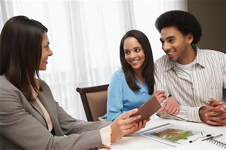 financial advisor talking to couple - Couple With Consultant Stock Photo - Premium Royalty-Free, Code: 600-01295590