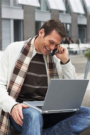 Man Using Laptop and Cellular Phone Stock Photo - Premium Royalty-Free, Code: 600-01295863