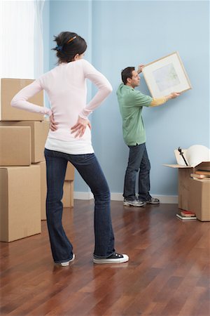 straighten - Couple Moving into New Home Stock Photo - Premium Royalty-Free, Code: 600-01345106