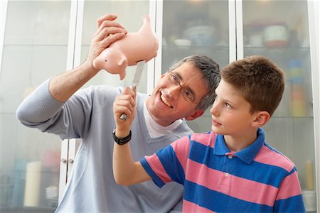 father advising son - Father and Son With Piggy Bank Stock Photo - Premium Royalty-Free, Code: 600-01374091
