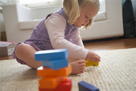 Girl Playing With Toys Stock Photo - Premium Royalty-Free, Code: 600-01374177