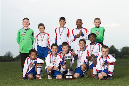 soccer shorts for boys - Portrait of Soccer Team With Gold Medals and Trophy Stock Photo - Premium Royalty-Free, Code: 600-01374817