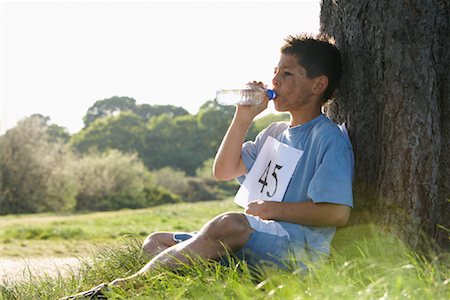 running finish - Boy Drinking Water After Race Stock Photo - Premium Royalty-Free, Code: 600-01374850