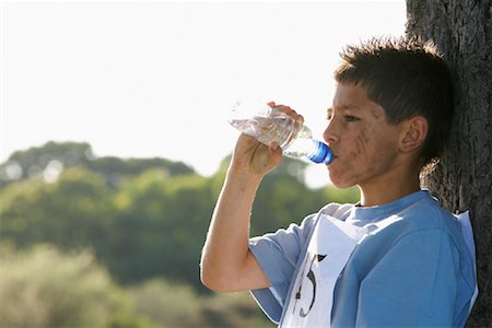 sweating running - Boy Drinking Water After Race Stock Photo - Premium Royalty-Free, Code: 600-01374851