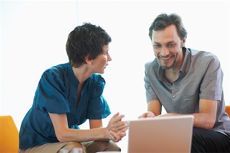 Man and Woman with Laptop Computer Stock Photo - Premium Royalty-Free, Code: 600-01464411