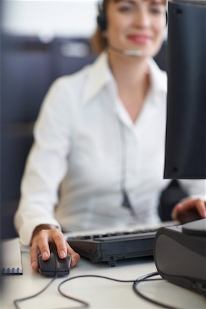 Businesswoman Working on Computer with Headset Stock Photo - Premium Royalty-Free, Code: 600-01464450