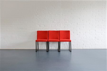 simsearch:600-07311305,k - Red Chairs against Wall Foto de stock - Sin royalties Premium, Código: 600-01519442