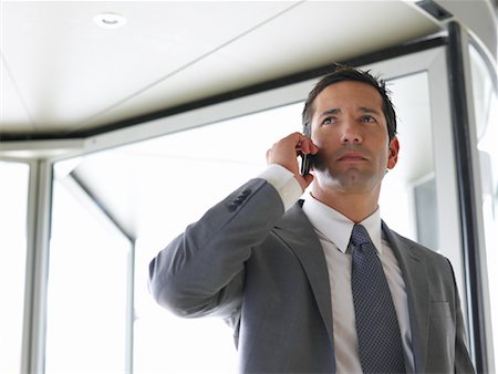 revolving door - Businessman Using Cellular Telephone Stock Photo - Premium Royalty-Free, Code: 600-01540577