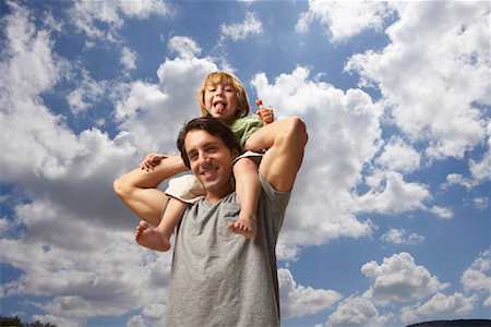 parents eating kids playing outside - Boy Riding on Father's Shoulders Stock Photo - Premium Royalty-Free, Code: 600-01540632