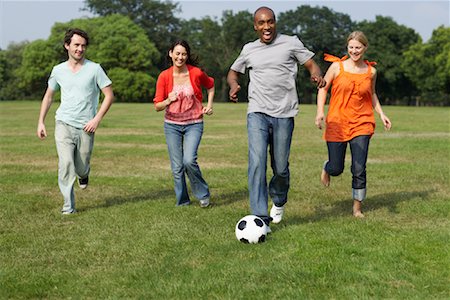 Friends Playing Soccer Outdoors Stock Photo - Premium Royalty-Free, Code: 600-01540710
