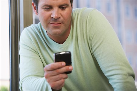 Businessman Reading Text Messages Stock Photo - Premium Royalty-Free, Code: 600-01540756