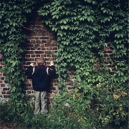 Boy Playing Hide and Seek Stock Photo - Premium Royalty-Free, Code: 600-01540970