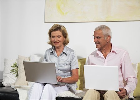 Couple Using Laptops Stock Photo - Premium Royalty-Free, Code: 600-01575636