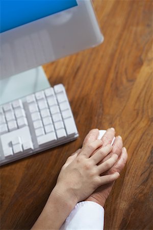 Child's and Adult's Hand Using Computer Mouse Stock Photo - Premium Royalty-Free, Code: 600-01575704