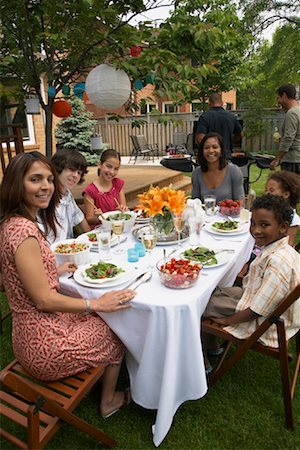 family eating back yard summer - People at Picnic Stock Photo - Premium Royalty-Free, Code: 600-01571861