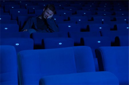 empty cinema - Man Sleeping in Movie Theatre Stock Photo - Premium Royalty-Free, Code: 600-01571999