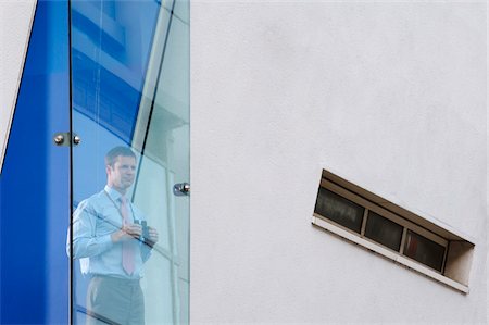 Businessman Looking out Window with Binoculars Stock Photo - Premium Royalty-Free, Code: 600-01572052