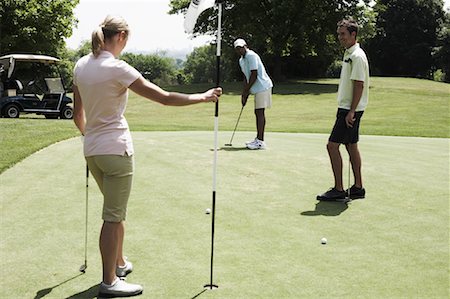 female golfers putting stances - Golfers Putting Stock Photo - Premium Royalty-Free, Code: 600-01581838