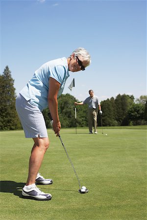 female golfers putting stances - Couple Golfing Stock Photo - Premium Royalty-Free, Code: 600-01581852