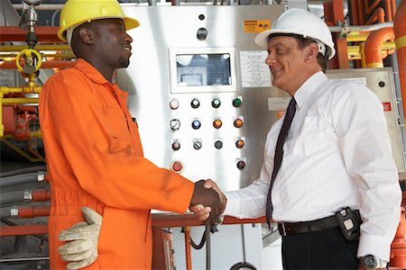 Workers Shaking Hands in Water Treatment Plant Stock Photo - Premium Royalty-Free, Code: 600-01582048