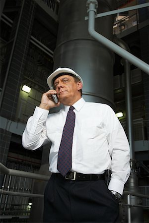 Businessman with Cellular Phone in Water Treatment Plant Stock Photo - Premium Royalty-Free, Code: 600-01582059