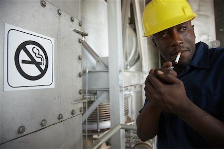 simsearch:700-01575435,k - Worker Smoking in No-Smoking Area Stock Photo - Premium Royalty-Free, Code: 600-01582077