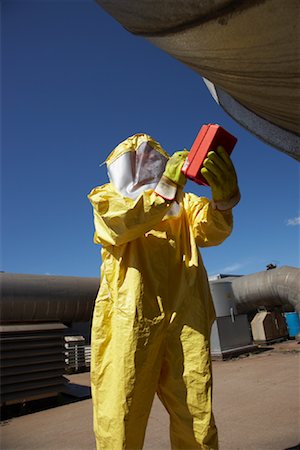 Man In Protective Clothing Examining Factory Stock Photo - Premium Royalty-Free, Code: 600-01582107