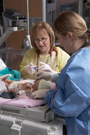 sick looking adult in hospital - Nurses Practicing with Baby Mannequin Stock Photo - Premium Royalty-Free, Code: 600-01595846