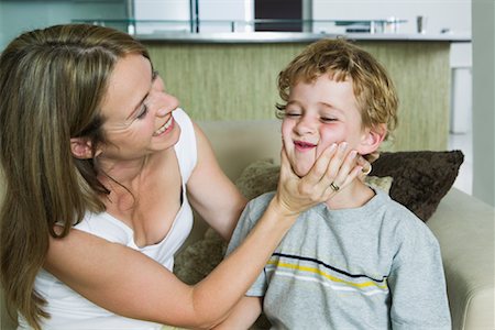 Mother Squeezing Son's Cheeks Stock Photo - Premium Royalty-Free, Code: 600-01593487