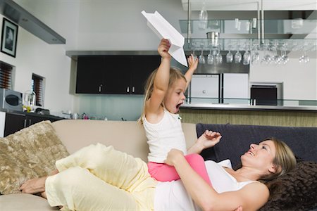 family and sitting in plane - Mother and Daughter Playing with Paper Airplane Stock Photo - Premium Royalty-Free, Code: 600-01593489