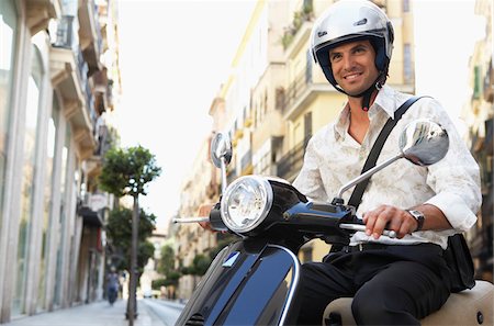 person riding bike - Man Riding Moped Stock Photo - Premium Royalty-Free, Code: 600-01593628