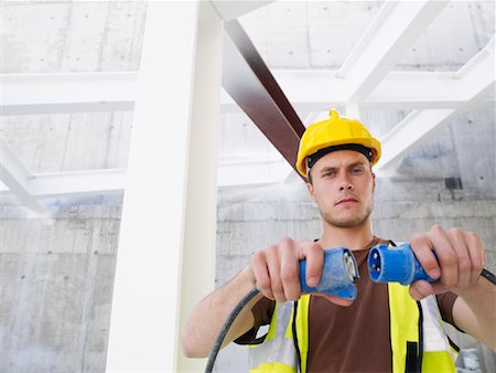 Construction Worker With Electrical Cord Stock Photo - Premium Royalty-Free, Code: 600-01593908