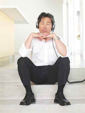 eyes closed portrait of asian man - Man Listening to Music Stock Photo - Premium Royalty-Free, Code: 600-01604077