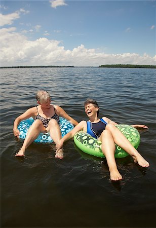 Women Floating on Lake Stock Photo - Premium Royalty-Free, Code: 600-01606105