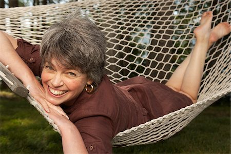 senior portrait not group not couple not child - Woman Lying in Hammock Stock Photo - Premium Royalty-Free, Code: 600-01606125