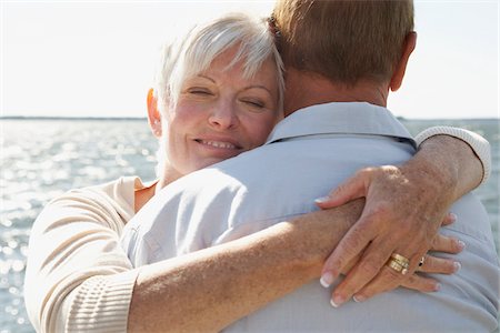 Couple Hugging by Water Stock Photo - Premium Royalty-Free, Code: 600-01606145