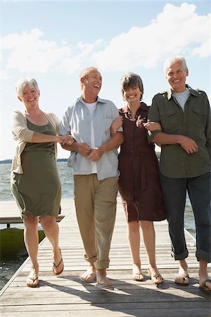 senior friends laughing - Couples Walking on Dock Stock Photo - Premium Royalty-Free, Code: 600-01606141