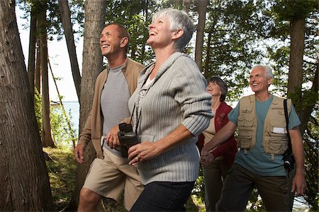 senior woman walking side view - Couples Walking through Woods Stock Photo - Premium Royalty-Free, Code: 600-01606163