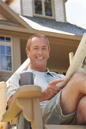 summer cottage casual - Man in Chair with Newspaper Stock Photo - Premium Royalty-Free, Code: 600-01606193