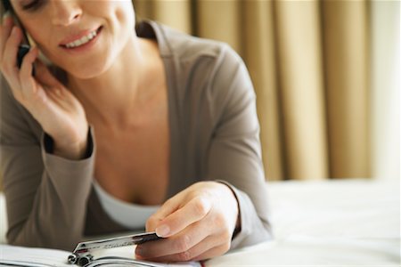 person on phone with a credit card - Woman Using Cellular Phone Stock Photo - Premium Royalty-Free, Code: 600-01606607