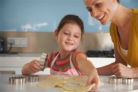 Mother and Daughter Making Cookies Stock Photo - Premium Royalty-Free, Code: 600-01606634