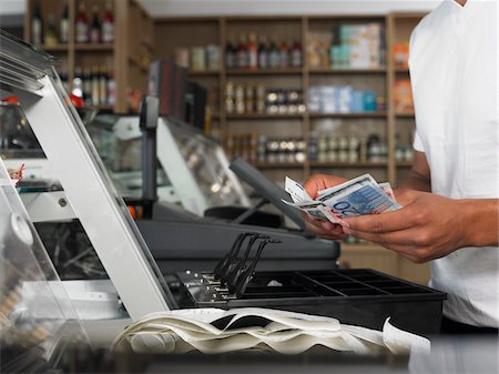 person counting money image - Man Counting Cash in Register Stock Photo - Premium Royalty-Free, Code: 600-01606696