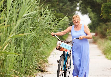 portrait woman senior 70 years old casual clothes not asian not hispanic - Portrait of Woman With Bicycle Stock Photo - Premium Royalty-Free, Code: 600-01606786