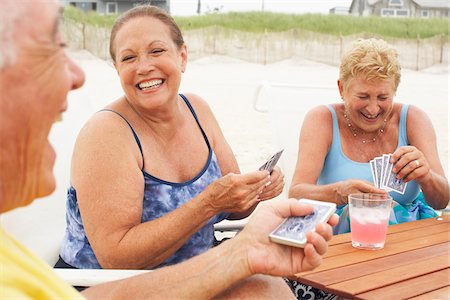 senior woman and swimsuit - Friends Playing Cards Stock Photo - Premium Royalty-Free, Code: 600-01606824