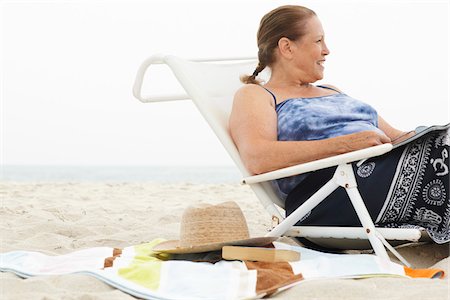 senior woman swimsuit sitting - Woman on the Beach Stock Photo - Premium Royalty-Free, Code: 600-01606835