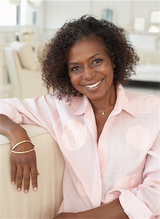 single middle aged african american woman looking at camera - Portrait of Woman Stock Photo - Premium Royalty-Free, Code: 600-01614025