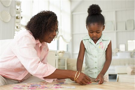 Mother and Daughter With Puzzle Stock Photo - Premium Royalty-Free, Code: 600-01614047