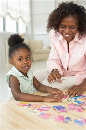 senior citizen african american - Mother and Daughter With Puzzle Stock Photo - Premium Royalty-Free, Code: 600-01614048