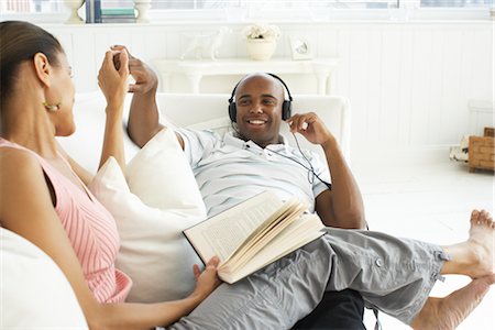 relaxing in couch black male - Couple Relaxing on Sofa Stock Photo - Premium Royalty-Free, Code: 600-01614120